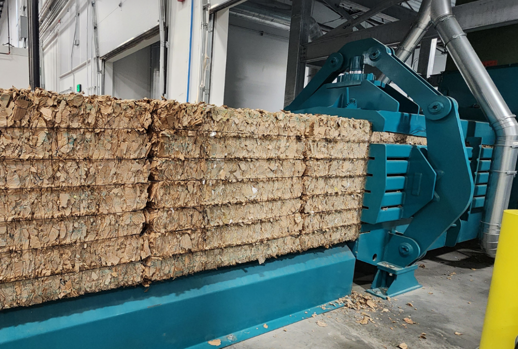 Komar horizontal baler compressing cardboard