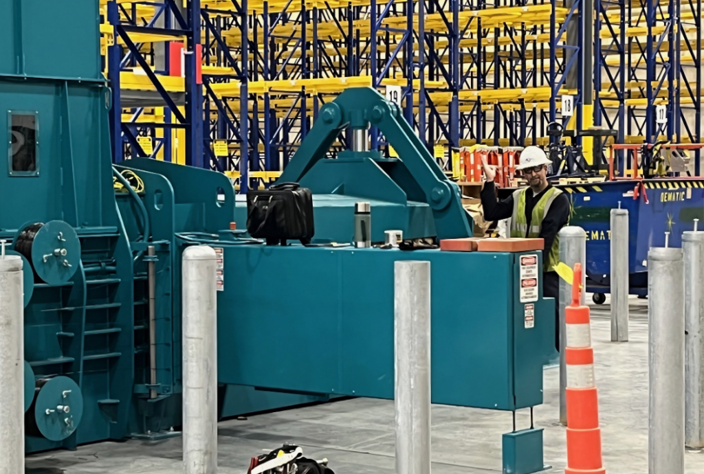Komar service tech working on a baler
